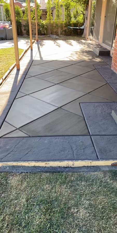 Image 3: A paito with a hash pattern in the concrete at a 45 deg angle.  It is bordered by stone.